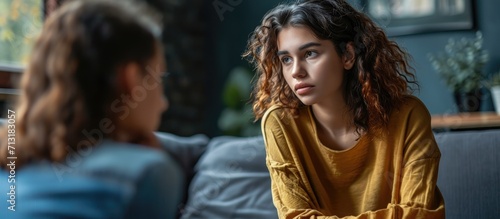 Young woman victim of domestic violence or robbery or mobbing at work talks to an expert psychotherapist for therapy in a comfortable apartment Psychologist discuss mental problems trauma after