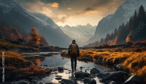 Amidst the tranquil fog and vibrant autumn landscape, a solitary figure stands in the river, surrounded by majestic mountains and a breathtaking sunset, lost in the wild beauty of nature while on a p