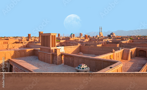 Historic City of Yazd with famous wind towers in the background full moon at sunset - Yazd, iran "Elements of this image furnished by NASA"