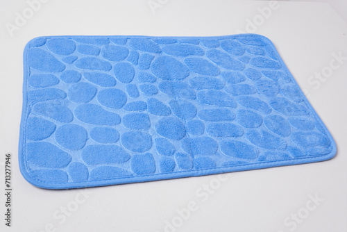 New bath mat isolated on white. Bathroom rug