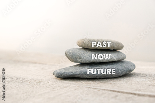Past, Now and Future words written on stones. Motivational advice or reminder