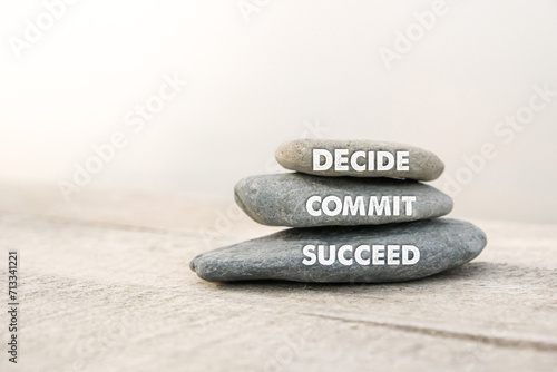 Decide, commit and succeed words written on stones. Motivational advice or reminder