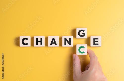 Hand holds wooden cube with word CHANGE to CHANCE. Personal development and career growth or change yourself concept. Thinking differently in new directions. Business opportunities and expansion.