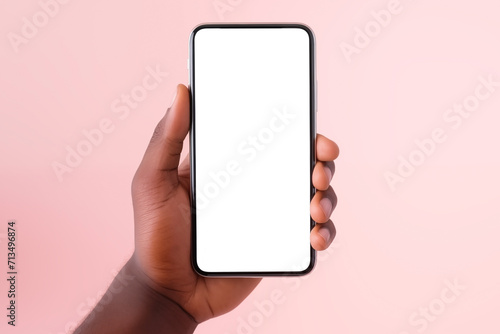 man's hand close-up holds smartphone with empty white screen, on pastel background