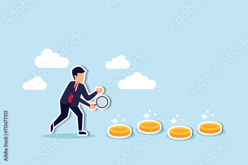 Searching for investment opportunity, financial success or salary raise, inspect way to make profit and earning concept, curios businessman with magnifier inspect and follow money coins trail.