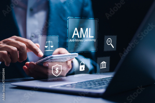 AML : Anti money laundering financial bank concept. businessman use laptop with virtual AML icon for anti money laundering regulations.