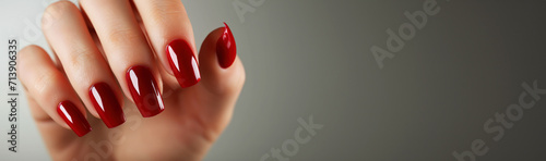 Woman hand with red nail polish on her fingernails. Manicure concept.