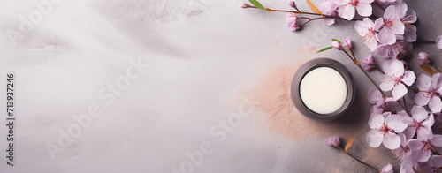 spa products on white table with fresh flower buds isolated on pink background, in the style of dark beige and gray, cherry blossoms, use of paper, dark violet and beige