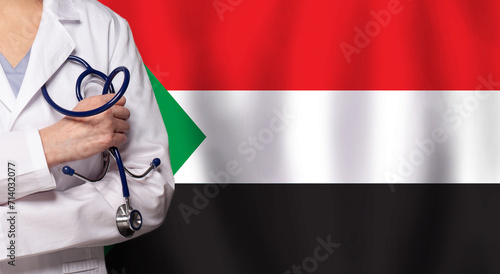 Sudanese medicine and healthcare concept. Doctor close up against flag of Sudan background