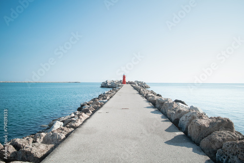 Breakwater with a red lighthouse