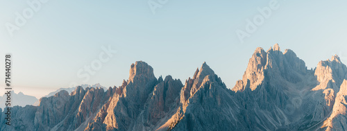 mountain ridge in the dolomites at sunrise with a blue sky