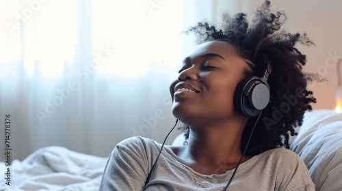 A young African American woman listens to music with pleasure, relaxes, immersing herself in the melody and her own thoughts. Creative concept for relaxation