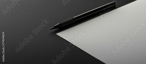 Blank sheet with light writing tool on black surface.