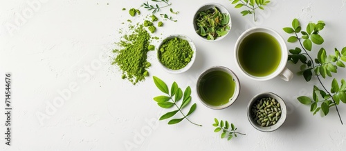 Moringa tea arranged creatively on a white surface in a flat lay style, showcasing food and macro concepts.