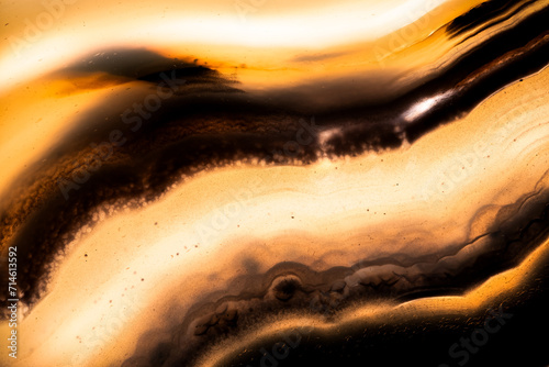 yellow and black tainted agate macro photography detail texture. close-up polished semi-precious gemstone. 