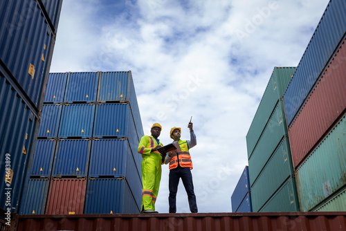 Foreman or worker work at Container cargo site check up goods in container. Foreman or worker checking on shipping containers. Logistics and shipping.