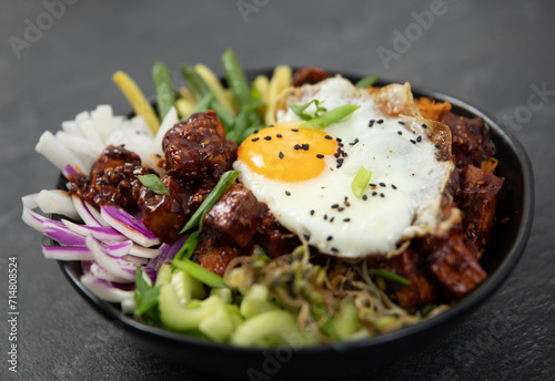 bibimap bowl with tofu, egg, celery, kimchi and black sesame