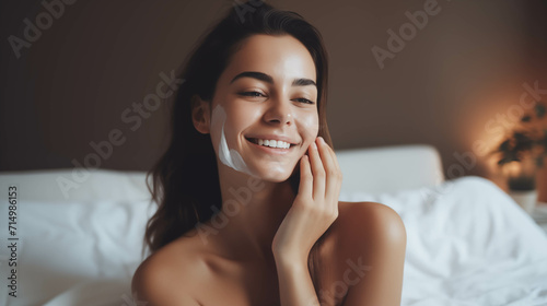 Caucasian woman taking care of her skin in the bedroom.