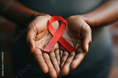 A person holding a red ribbon with a red AIDS ribbon Generative AI