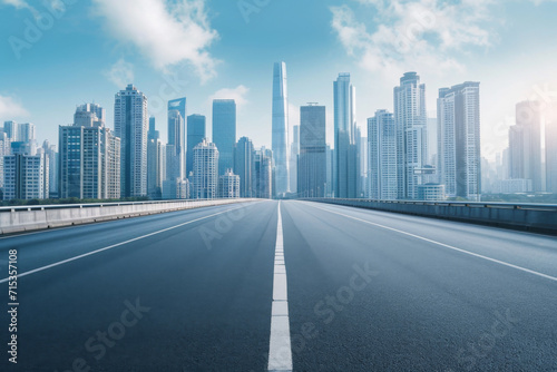 An empty road with skyscrapers in the background,