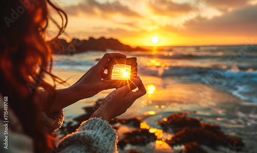 Creative traveler framing the setting sun with fingers on a beach, capturing the essence of wanderlust and destination dreaming