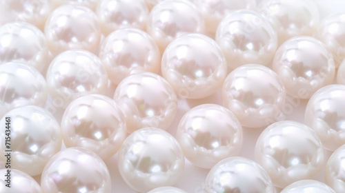 Close-up image of multiple smooth and shiny white pearls scattered on a surface, representing luxury, elegance, or a concept related to jewelry