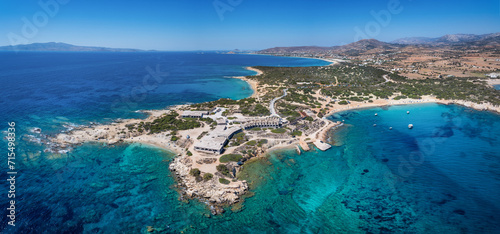 Aerial view of the Alyko peninsula with the Cedar forest, beaches and dunes next to emerald sea, Naxos island, Cyclades, Greece
