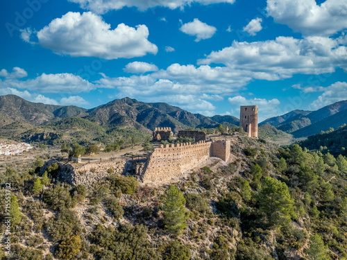 Aerial view of Almonecir Castle, in the Sierra de Espadán above Vall de Almonacid, irrigated farmlands and an extensive olive groves with horseshoe shaped great tower partially restored