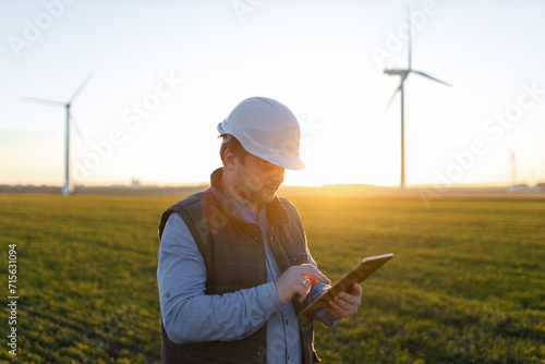 Businessman checking on wind turbine energy production