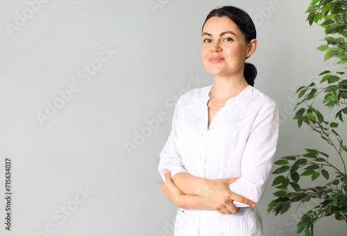Smiling medical woman doctor overlight grey background