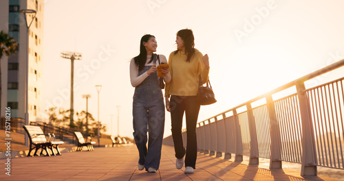 Walking, women and friends with smartphone, outdoor and happiness with social media, connection and sunshine. People, Japan or girls with cellphone, mobile user and funny with network or digital app