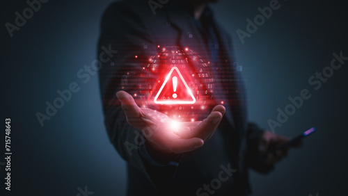 Warning alert icon with a hacked system. malicious software, virus, spyware, malware, or cyberattacks on computer networks. Security on the internet and online scam. Digital data is being compromised.