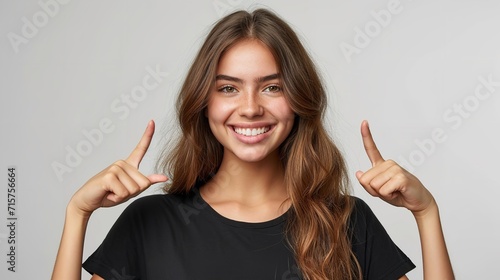 Portrait of an American woman in black t shirt indicating two forefingers up in a clean backdrop with copy space, Generative AI.