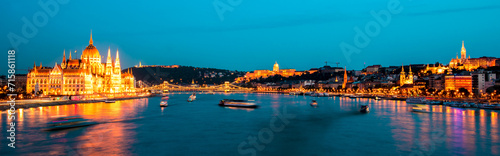 The picturesque landscape of the Parliament, the famous Szechenyi chain bridge over the Danube, Fishermen's Bastion in Budapest, Hungary at night. Panorama viev. Charming places.