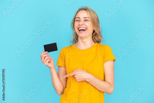 Happy woman pointing at bank card with amazing and easy customer service
