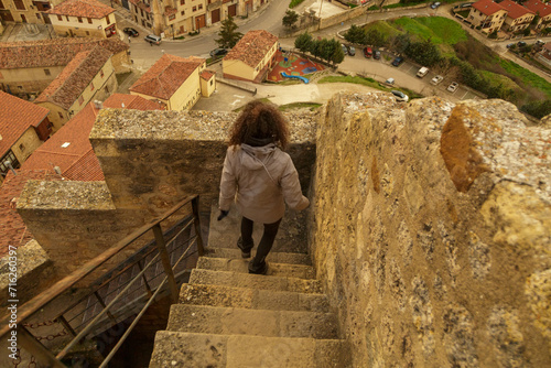 Young woman inside the Frias castle in Burgos. Located in Castilla y Leon, Spain. Old fortification