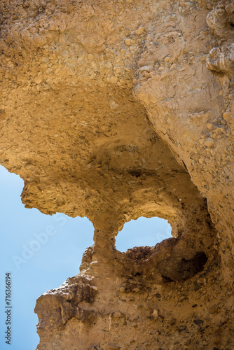 hole in worn sandstone cliffs at narrow Serisem canyon, Naukluft desert, Namibia
