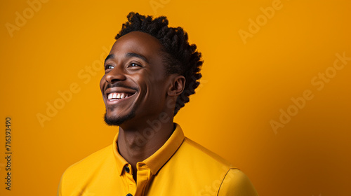 young black man happy, confident, satisfied expression, lateral view against orange wall
