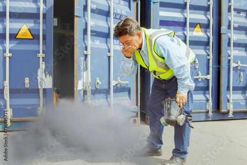 Male worker was about inspect the container holding chemical ammonia protection mask felt stink and felt dizzy because inhaled toxic fumes chemicals that were toxic to the respiratory 