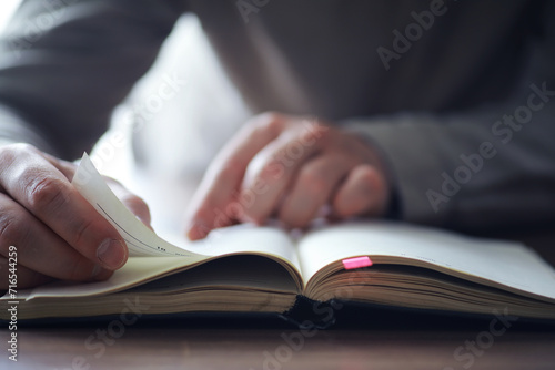Read book. A man sits and reads literature. Textbooks to study. Religion.