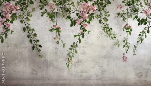 hanging branches on which flower buds with leaves on a textured worn wall photo wallpaper in the interior