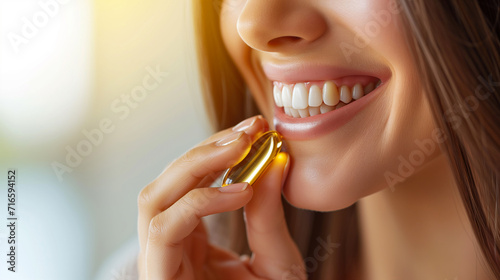 healthy eating concept, woman taking fish oil hand holding capsule vitamin