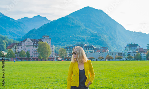 Vacation in Switzerland - Interlaken. Concept of tourism and holidays. Woman in city streets, urban scene