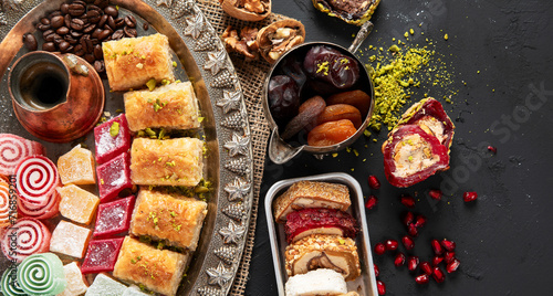 Traditional turkish coffee and turkish delight on dark background.