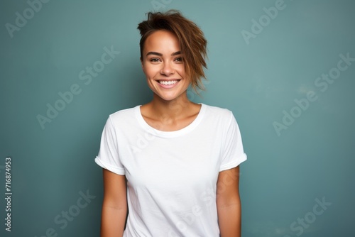 Portrait of a happy woman in her 20s dressed in a casual t-shirt against a plain cyclorama studio wall. AI Generation