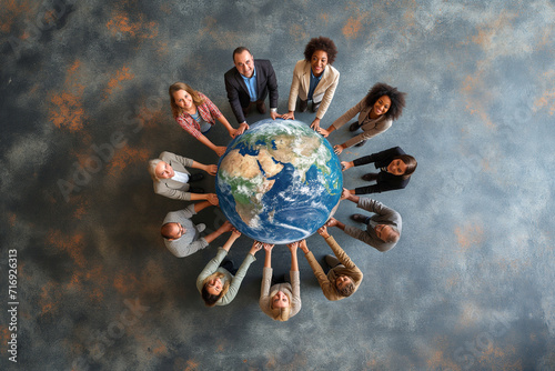 A group of business people holding a planet earth globe together