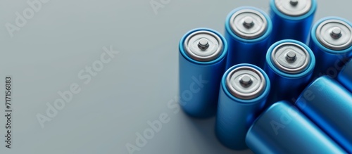 5 rechargeable lithium ion batteries type 18650, in blue, placed on a light gray background, suitable for electrical devices and appliances, and can act as a secondary storage cell.