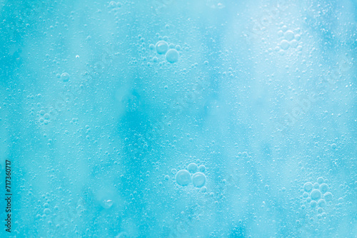 Air bubbles in the water background.Abstract oxygen bubbles in the sea.Water bubbles isolate on blue background.Sunlight underwater with bubbles rising to water surface in the sea