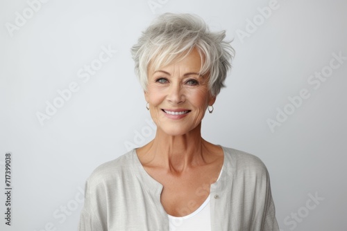 Portrait of happy senior woman with grey hair, looking at camera.
