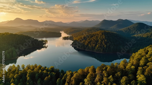 Beautiful landscape of green mountains and lake in the morning with sunrise sky. Nature landscape. Watershed forest. Water and forest sustainability concept. Aerial view of mountain with green trees